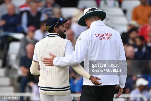 India's captain Virat Kohli talks to the umpire on the fourth day of the first cricket Test match of the India Tour of England 2021 between England...