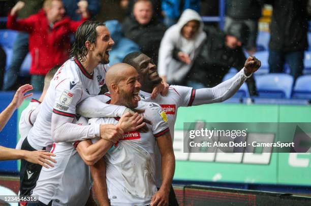 Bolton Wanderers' Alex John-Baptiste celebrates scoring his side's third goal with teammates during the Sky Bet League One match between Bolton...