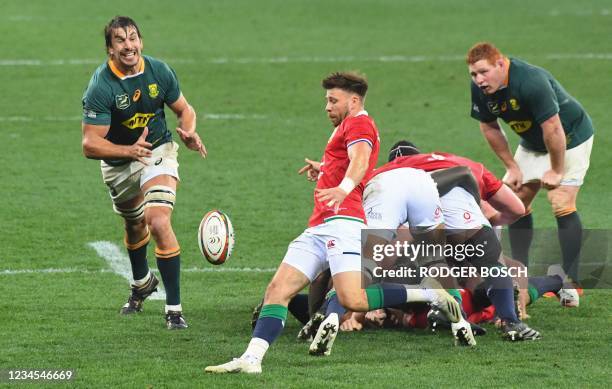 British and Irish Lions' scrum-half Ali Price kicks the ball as South Africa's lock Eben Etzebeth attempts a charge down during the third rugby union...