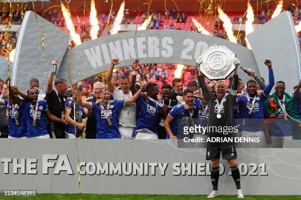 Leicester City's Danish goalkeeper Kasper Schmeichel holds aloft the Community Shield trophy after winning the English FA Community Shield football...