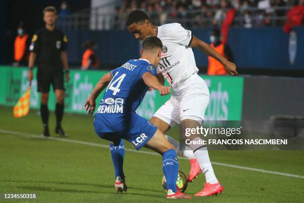 Troyes' French midfielder Dylan Chambost fights for the ball with Paris Saint-Germain's French defender Abdou Diallo during the French L1 football...