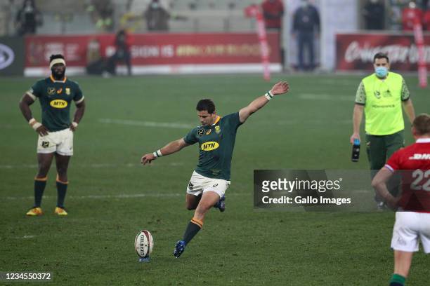 Morne Steyn of South Africa kicks the winning penalty in the match with South Africa captain Siya Kolisi and South African Director of Rugby Rassie...