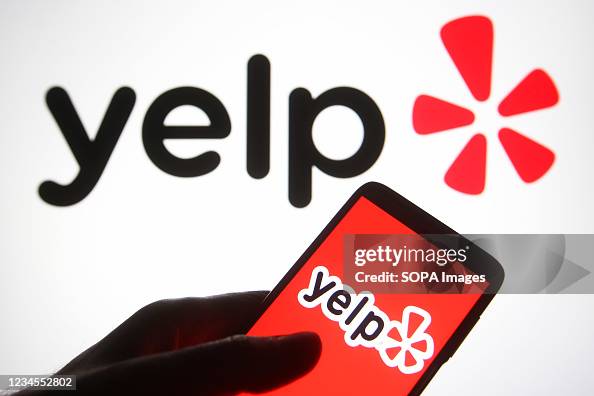 In this photo illustration a Yelp logo is seen on a In this photo illustration a Yelp logo is seen on a