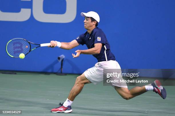 Mackenzie McDonald of the United States returns a shot during the semi-final match against Kei Nishikori of Japan on Day 8 during the Citi Open at...