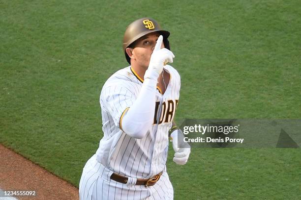 Manny Machado of the San Diego Padres points skyward after hitting a solo home run during the first inning of a baseball game against the Arizona...