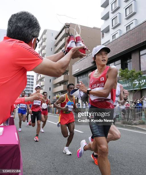 Japan's Suguru Osako takes a drink during the men's marathon at the Tokyo Olympics on Aug. 8 in Sapporo, northern Japan.