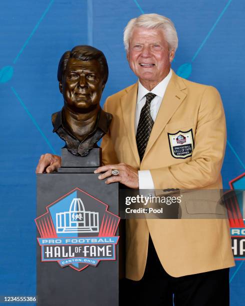 Jimmy Johnson, a member of the Pro Football Hall of Fame Centennial Class, poses with his bust during the induction ceremony at the Pro Football Hall...