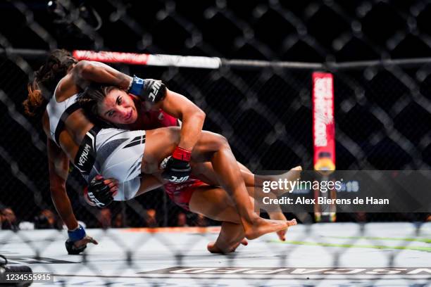 Tecia Torres tackles Angela Hill in the 3rd round during their Strawweight fight at Toyota Center on July 7, 2021 in Houston, Texas.