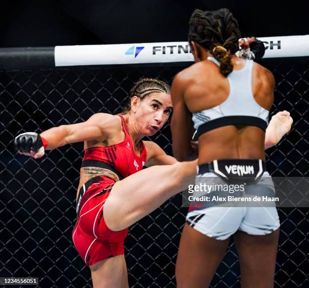 Tecia Torres kicks Angela Hill in the 2nd round during their Strawweight fight at Toyota Center on July 7, 2021 in Houston, Texas.