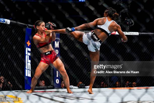 Angela Hill lands a kick on Tecia Torres during their Strawweight fight at Toyota Center on July 7, 2021 in Houston, Texas.