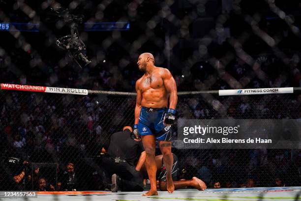 Ciryl Gane looks to his coaches after defeating Derrick Lewis in the third round of their Heavyweight bout at Toyota Center on July 7, 2021 in...