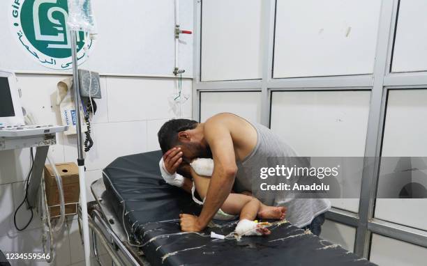 Wounded child is brought to a hospital after Assad regime's attacks on residential areas in rural Hama, Syria on August 08, 2021.