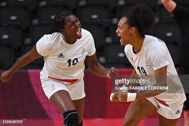 France's centre back Grace Zaadi Deuna and France's right back Oceane Sercien Ugolin celebrate a goal during the women's final handball match between...
