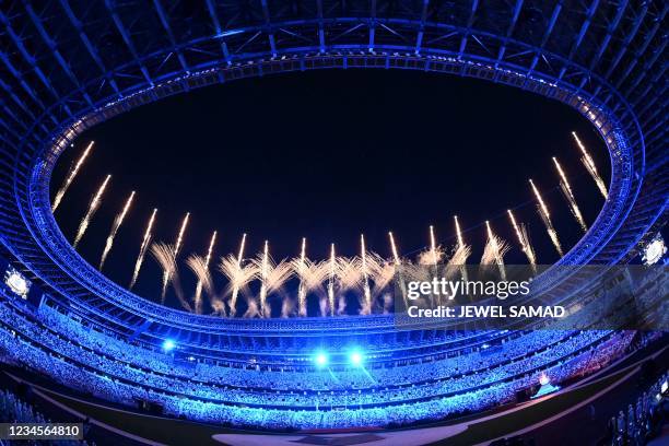 Fireworks go off around the Olympic Stadium during the closing ceremony of the Tokyo 2020 Olympic Games, in Tokyo, on August 8, 2021.