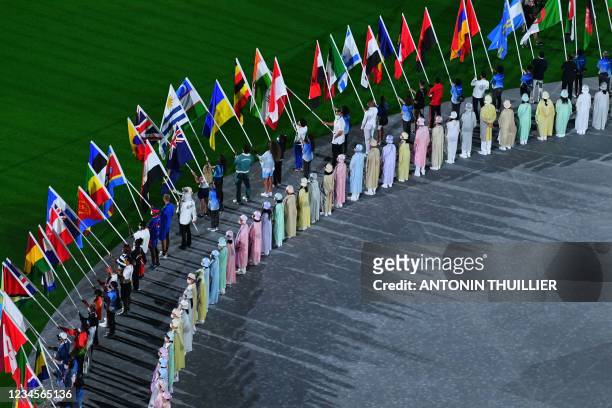 Athletes delegations arrive with their national flag during the closing ceremony of the Tokyo 2020 Olympic Games, at the Olympic Stadium, in Tokyo,...