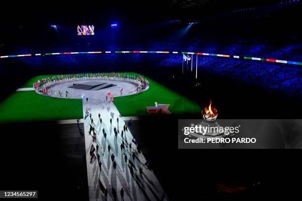 Flagbearers take part in the closing ceremony of the Tokyo 2020 Olympic Games, at the Olympic Stadium, in Tokyo, on August 8, 2021.