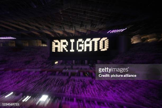 August 2021, Japan, Tokio: Olympics: Closing ceremony in the Olympic Stadium. The lettering "Arigato" on a scoreboard. Photo: Michael Kappeler/dpa