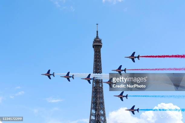 French Elite acrobatic team Patrouille de France flyes over the Eiffel Tower during the Olympic Games handover ceremony on August 08, 2021 in Paris,...