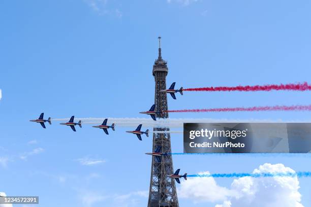 French Elite acrobatic team Patrouille de France flyes over the Eiffel Tower during the Olympic Games handover ceremony on August 08, 2021 in Paris,...