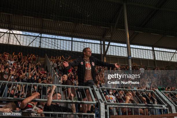 Fans of FC St. Pauli celebrate with the team the victory in the DFB CUP first round match match between 1. FC Magdeburg and FC St. Pauli at...