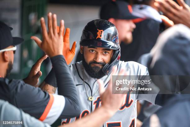 Derek Hill of the Detroit Tigers celebrates in the dugout with teammates after hitting a homer against the Cleveland Indians during the top of the...