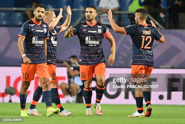 Montpellier's players react after scoring a goal during the French L1 football match between Montpellier and Marseille at the Mosson stadium in...