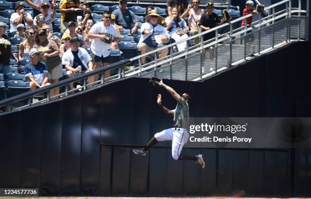 Tommy Pham of the San Diego Padres makes a leaping catch on a foul ball hit by Ketel Marte of the Arizona Diamondbacks during the first inning of a...