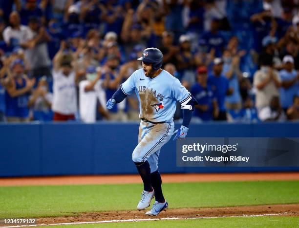 George Springer of the Toronto Blue Jays celebrates his 3-run game winning home run during the eighth inning during a MLB game against the Boston Red...