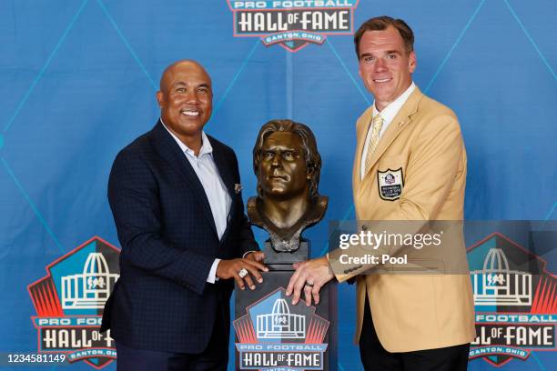 Alan Faneca poses with presenter Hines Ward during the induction ceremony for the NFL Hall of Fame at Tom Benson Hall Of Fame Stadium on August 8,...
