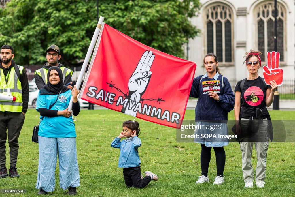 A protester holds a flag that says Save Myanmar during the...