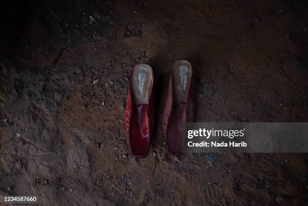 Pair of red shoes that belongs to Hawa Harouda, who is amongst the victims of Al-Kaneyat massacres, in her abandoned storage on February 22, 2021 in...