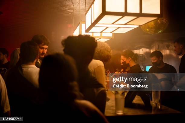 Bar staff serve clubbers inside The Berkeley Suite nightclub, after most coronavirus restrictions were lifted in Scotland, in Glasgow, U.K., on...