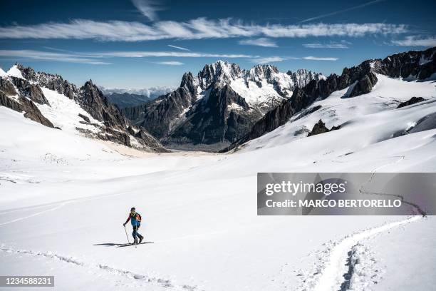 Skier walks on the glacial troughs the Vallee Blanche in the Mont Blanc Massif on August 6, 2021.