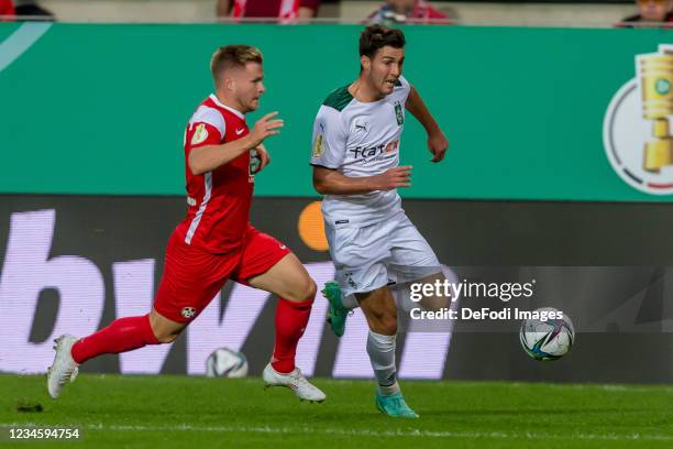 Jean Zimmer of 1. FC Kaiserslautern and Joseph Michael Scally of Borussia Moenchengladbach battle for the ball during the DFB Cup first round match...