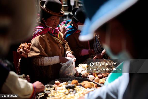 Woman takes part of an ¨Apthapi¨ Aymara collective celebration in which food is shared during the presentation of Saphi, a mummified Inca girl...