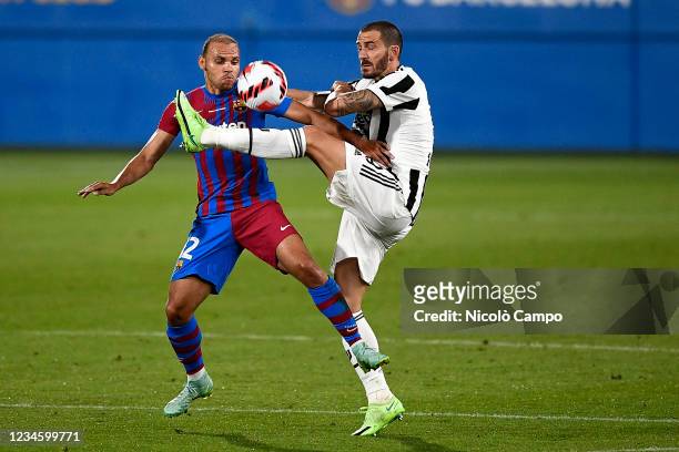 Martin Braithwaite of FC Barcelona competes for the ball with Leonardo Bonucci of Juventus FC during the pre-season friendly football match between...