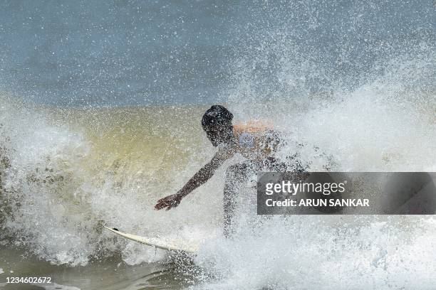 Man surfs during the annual Covelong Point Classic Surf festival at Kovalam on the outskirts of Chennai on August 10, 2021.