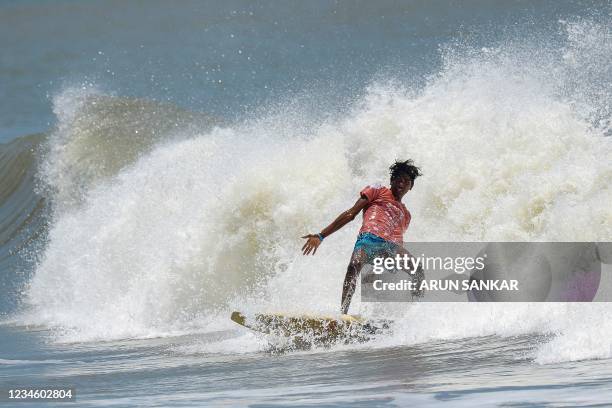 Man surfs during the annual Covelong Point Classic Surf festival at Kovalam on the outskirts of Chennai on August 10, 2021.