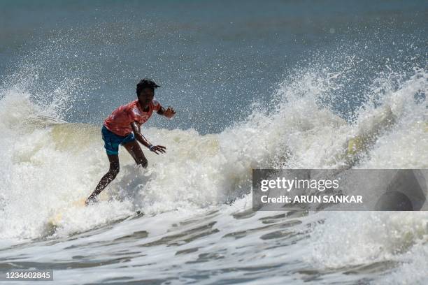 Man surfs during the annual Covelong Point Classic Surf festival at Kovalam on the outskirts of Chennai on August 10, 2021.