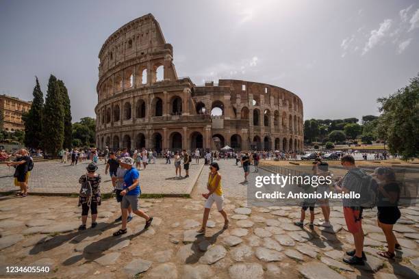 People refresh themself because off high temperatures around 39 degrees Celsius, at Colosseum on August 10, 2021 in Rome, Italy. With the arrival of...