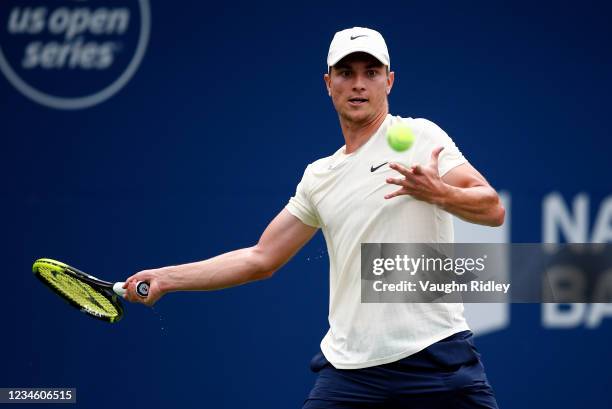 Miomir Kecmanovic of Serbia hits a shot against Kei Nishikori of Japan during the second round on Day Two of the National Bank Open at Aviva Centre...