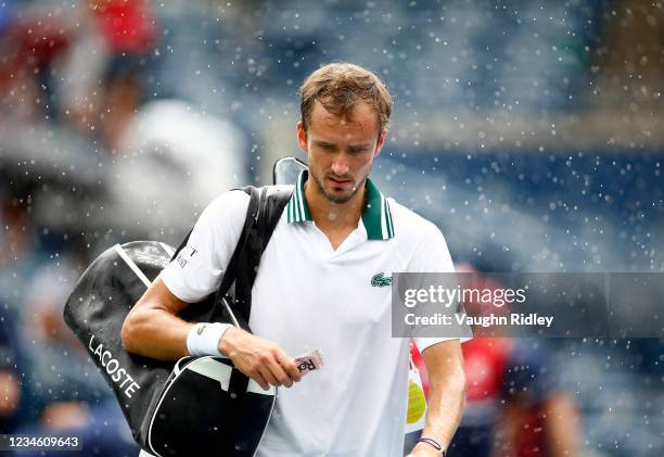 Daniil Medvedev of Russia leaves the court as rain halts play during his second round match against Alexander Bublik of Kazakhstan on Day Two of the...