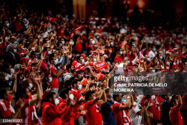 Benfica's supporters celebrate at the end of the UEFA Champions League third round second leg qualifying football match between SL Benfica and...