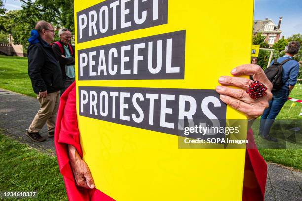 Protester carries a placard denouncing the Lukashenko regime during the protest. For exactly one-year, peaceful civilian protests in Belarus have...