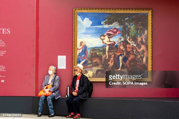 People sit by Titian's Bacchus and Ariadne during an outdoor pop-up gallery showcasing over 20 full sized reproductions of popular National Gallery...