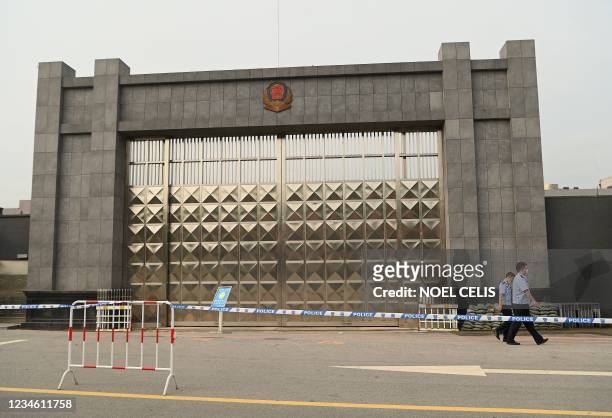 Policemen walk in front of the Dandong city detention center where Canadian businessman Michael Spavor is being held on spying charges in the border...