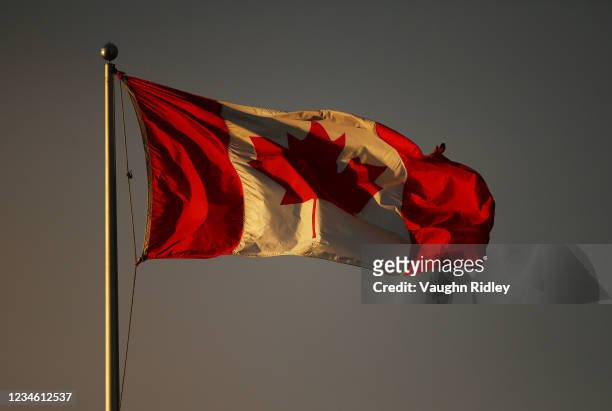 Canadian flag flutters in the late evening light above Centre Court on Day Two of the National Bank Open at Aviva Centre on August 10, 2021 in...