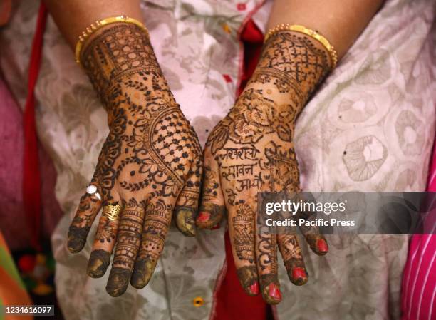 Indian woman displays her henna'd hands on the occasion of Sinjara festival ahead of Sawan Teej in Beawar.