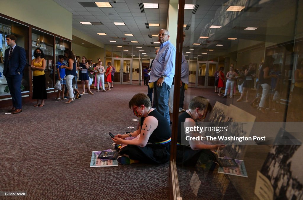 ASHBURN, VA - AUGUST 10: People wait in line to speak in person