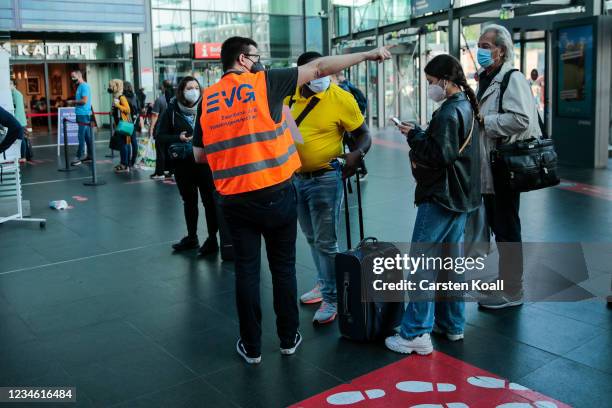 Members of the Railway and Transport Union explain the strike timetable to travelers in Berlin Central Station during a railway strike which has...